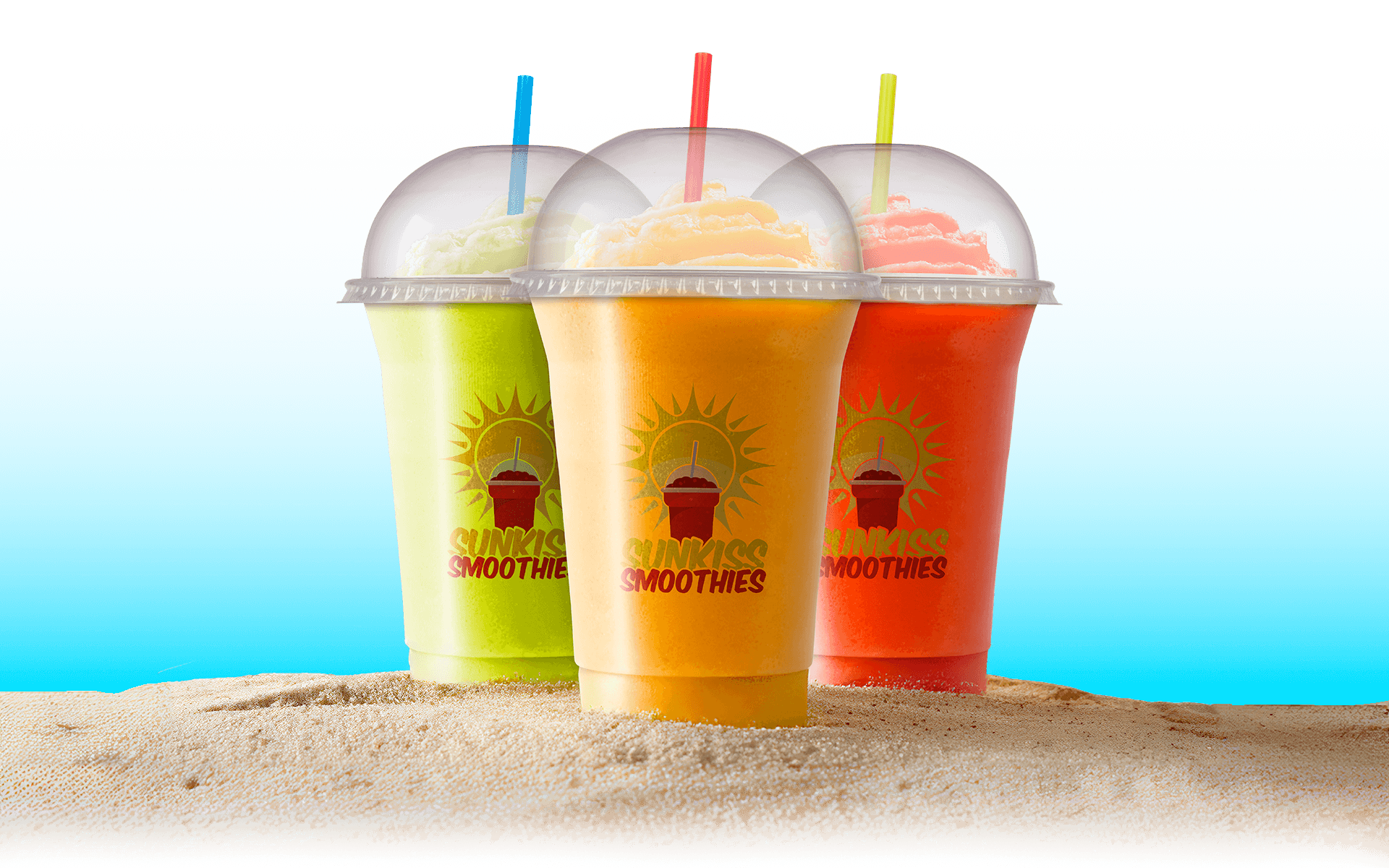 Three colorful Sunkiss Smoothies on a sandy beach